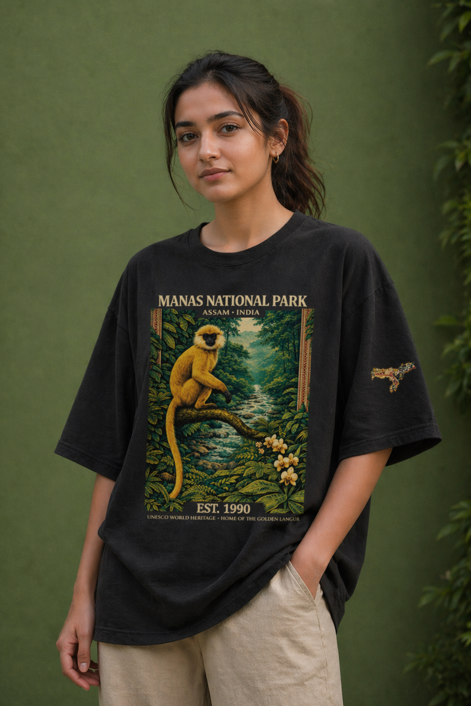Person wearing a black t-shirt with a graphic design of a monkey and text on a green background