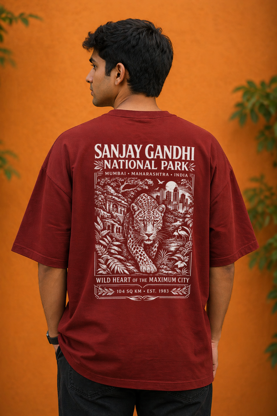 Person wearing a maroon t-shirt with 'Sanjay Gandhi National Park' design on an orange background

