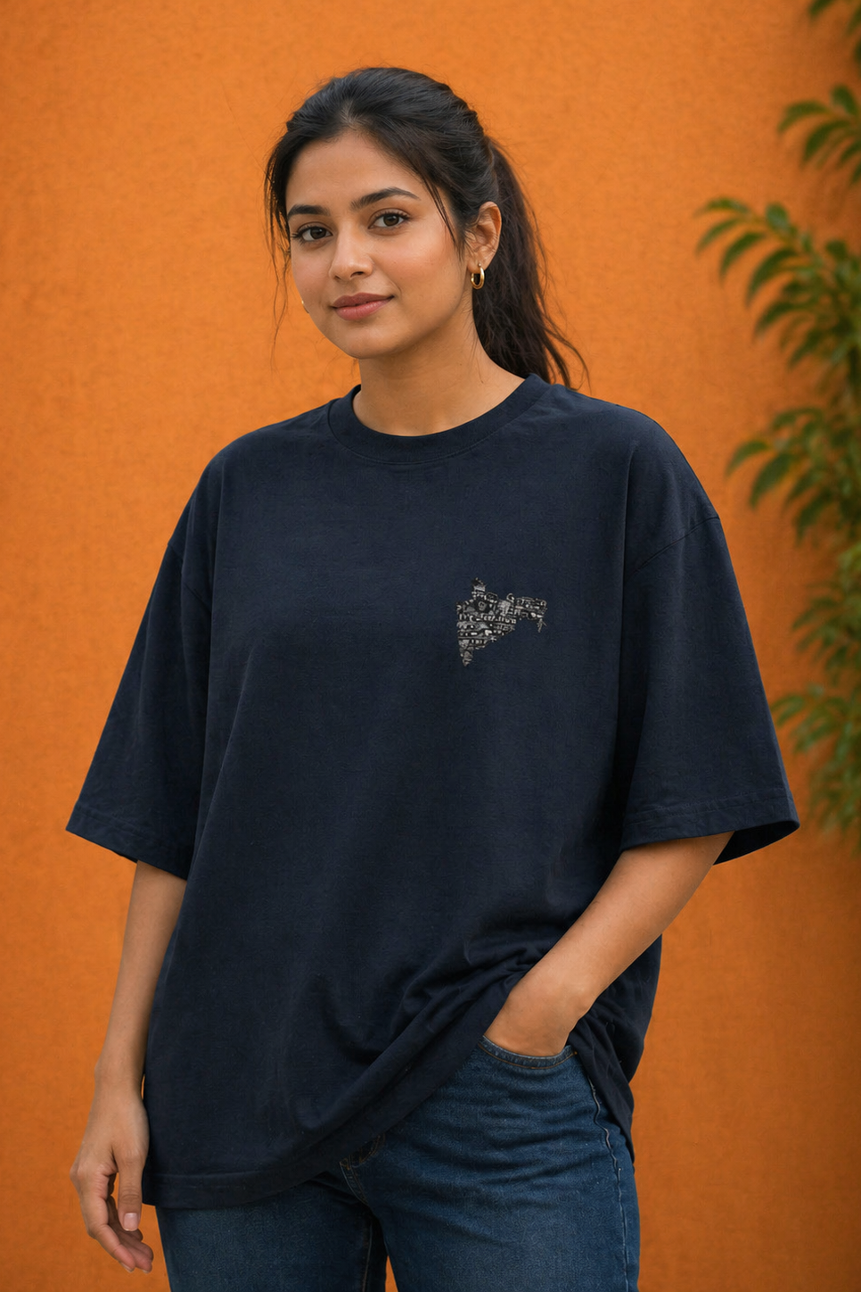 Woman wearing a navy blue t-shirt with a small design on an orange background