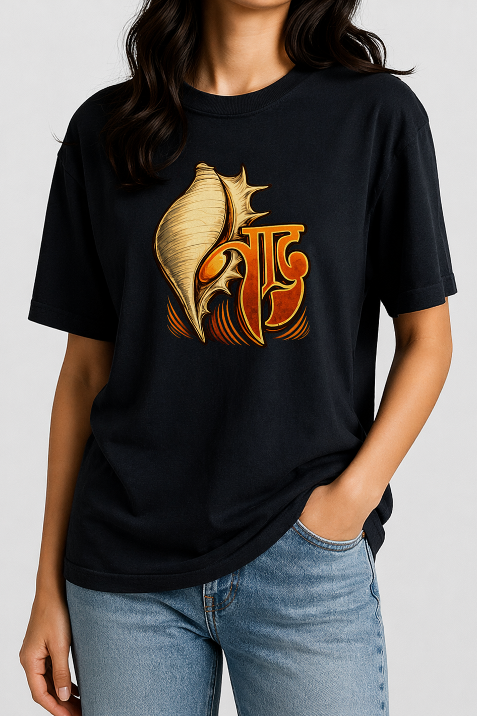 Person wearing a black t-shirt with a gold and orange design on a plain background
